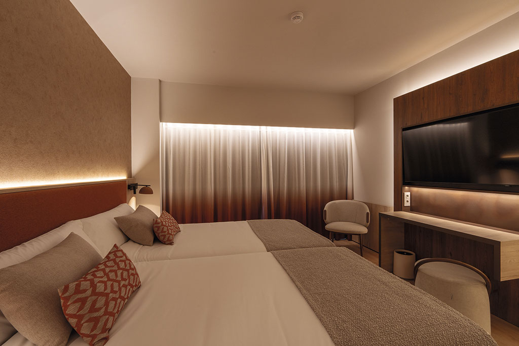 Zona interior del Hotel Turia Badajoz con mobiliario, textiles y tonos tierra.